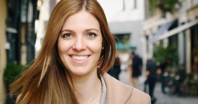 Mix of people of different ethnicity, sex and age are smiling in camera.