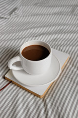 white cup with a pattern of deer. Coffee in a cup. Morning coffee.