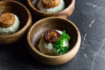 Scallops on Mashed Potatoes with Lime on Slate