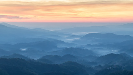 mountains valley with the sea of fog and clouds.Layers of mountains in morning sunrise.