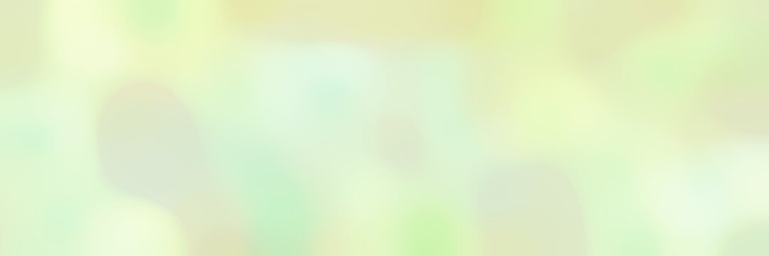 blurred bokeh horizontal background with tea green, pale golden rod and honeydew colors and free text space