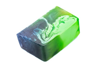 Handmade soap bar with green grapes isolated on a white background.