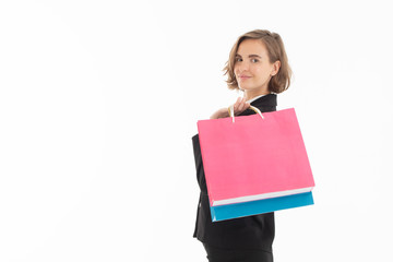 Portrait of young business woman holding shopping bags on white isolated background.