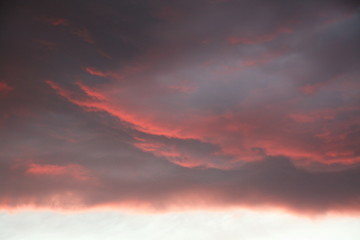 Red clouds in overcast sky