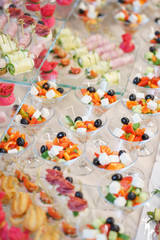 Obraz na płótnie Canvas Catering and guest meals during the event. Quick mini snacks in a special beautiful dish.