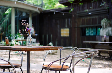 Table and chair are outdoor in the coffee shop.
