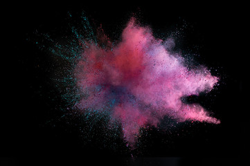 Colored powder explosion. Abstract closeup dust on backdrop. Colorful explode. Paint holi