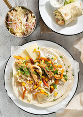 Coleslaw Chicken Wraps or tacos with mixed vegetables. Top view, hard light. Delicious snack.