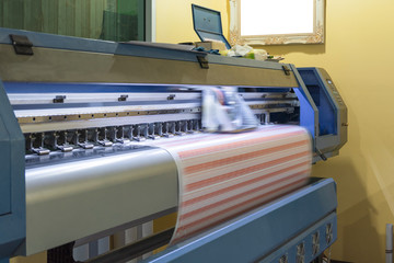 Large format inkjet printer working on sticker sheets