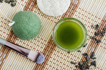 Homemade natural face toner (infusion, tincture) with matcha powder. Diy green tea cosmetics recipe. Top view, copy space 