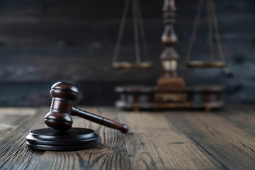 Law concept. Judge’s gavel and scale on dark background.