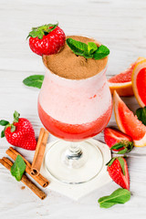 Strawberry and tequila berry cocktail shot closeup vertical