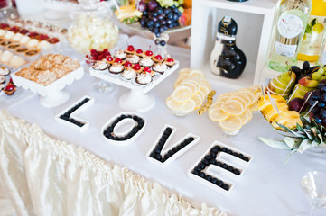 Dessert table of delicious sweets on wedding reception.
