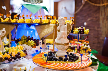 Dessert table of delicious fruits on wedding reception.