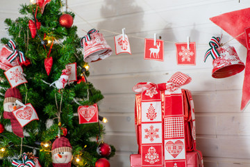 red Christmas gifts next to Christmas tree