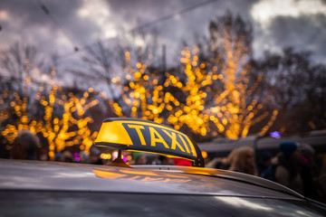 Taxi car cab at city street near Christmas market in Rathausplatz, Vienna