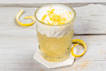 Cocktail with egg and lemon in a glass cup