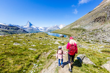 Naklejka na ściany i meble Family trekking, mother and daughter camping