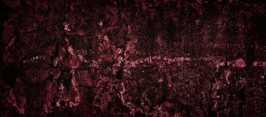 Old cracked shabby red concrete wall texture. Dark gloomy sinister widescreen background