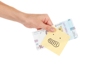 Thousand hryvnias and sticker with emoji, in the hand, isolated