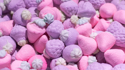 Candy marmalade marshmallow pink lilac in the shape of a raspberry strawberry berry. Background...