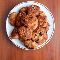 juicy fried meatballs on a plate with a golden border