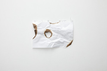 top view of empty crumpled and burnt vintage paper on white background