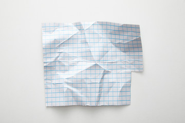 top view of empty crumpled grid paper on white background