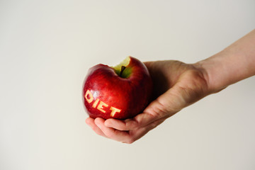 Big red apple in woman hand