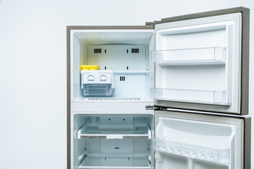 empty open fridge and freezer isolated on white
