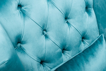 close up view of elegant velour blue armchair with pillow