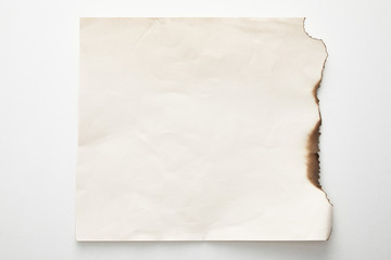 Obraz premium top view of empty burnt vintage paper on white background