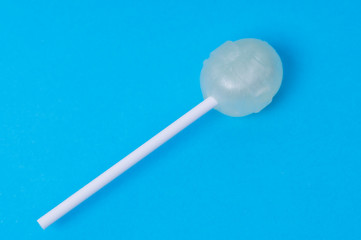 Lollipop on blue background close-up, sweet gift