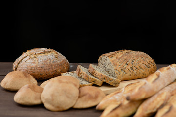 Different homemade bread. Isolated on dark background. Empty space for text