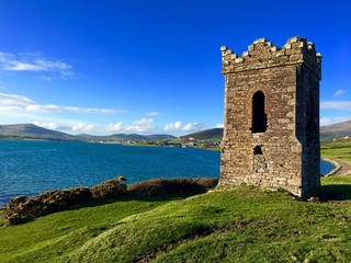 Old stony lighthouse by the sea