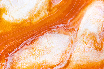 Burnt orange liquid and white foam mixing raster background. Colorful fluid splashes realistic...
