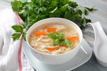Chicken soup with noodles and vegetables in bowl. Healthy food concept