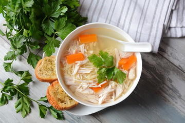 Chicken soup with noodles and vegetables in bowl. Healthy food concept