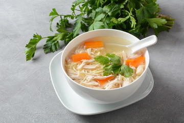 Chicken soup with noodles and vegetables in bowl. Healthy food concept