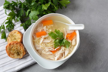Chicken soup with noodles and vegetables in bowl. Healthy food concept