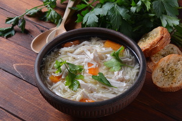 Chicken soup with noodles and vegetables in bowl. Healthy food concept