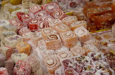 Assorted traditional turkish delight . traditional sweets, rahat lukum in counter in the market.