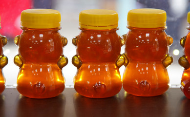 Glass jars filled with honey on the store counter