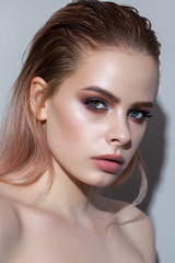 Beautiful young model with professional make up, perfect skin. Trendy purple smokey eyes