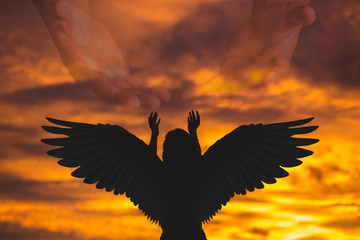 The shadow of a woman raised her hand to pray to God in heaven Style Silhouette Image