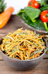 Uncooked vegetable noodles with fresh vegetables.