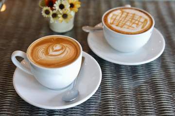 hot caramel macchiato and latte coffee drink put on table in cafe