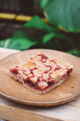 Homemade raspberry crumble bar on plate