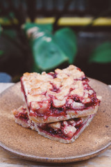 Homemade raspberry crumble bar on plate