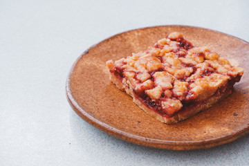 Homemade raspberry crumble bar on plate